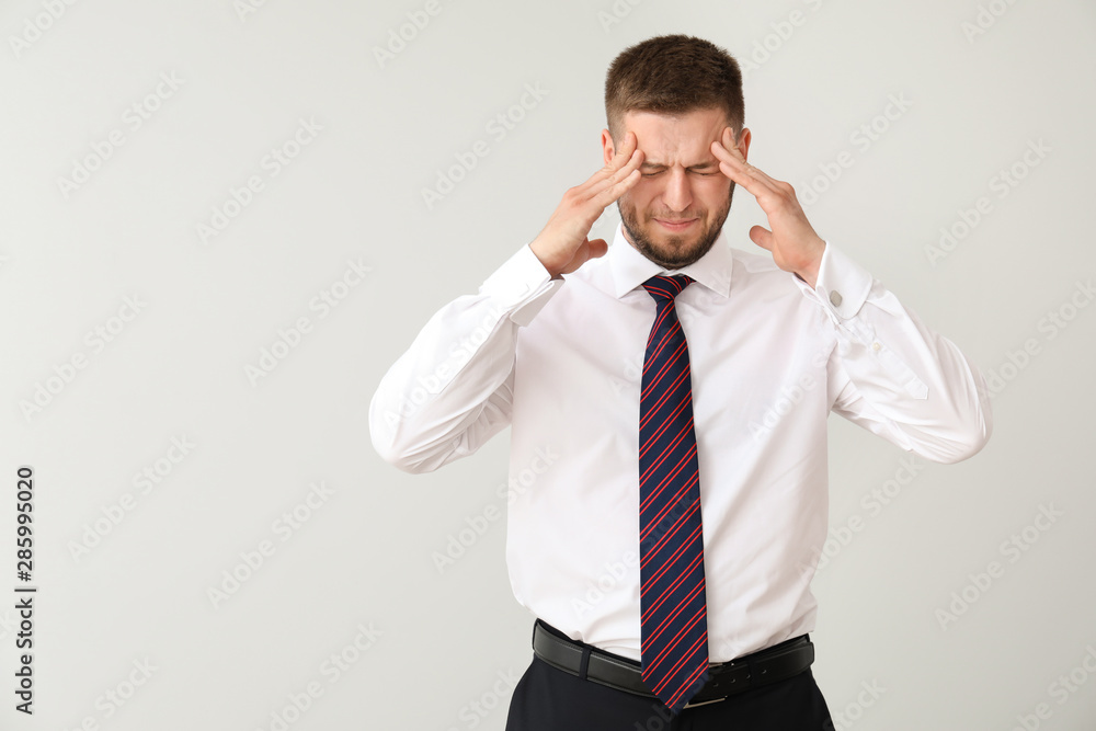 Businessman having panic attack on light background Businessman having panic attack on light background