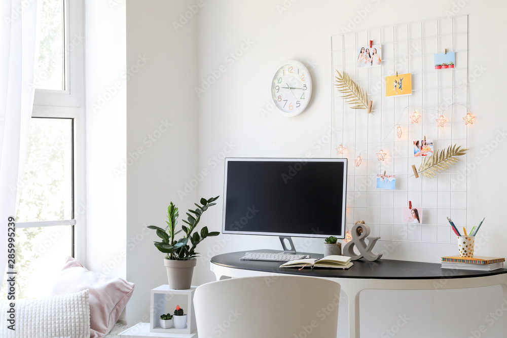 Workplace with mood board and computer in modern room Workplace with mood board and computer in modern room