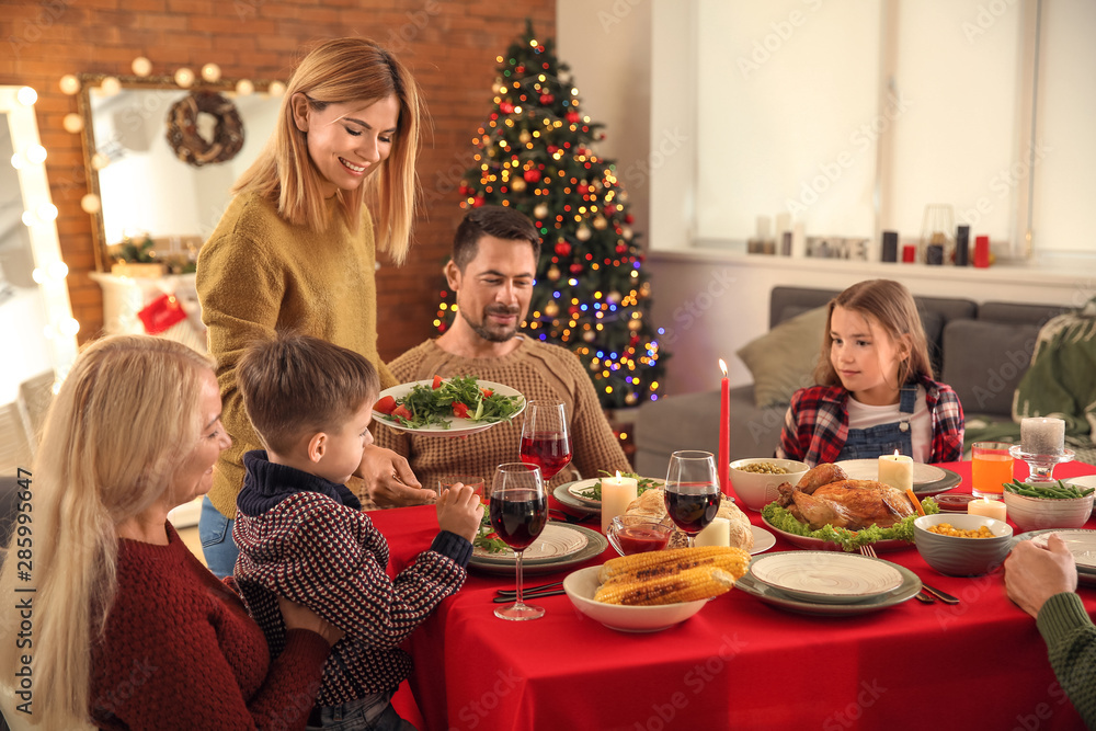 Happy family having Christmas dinner at home