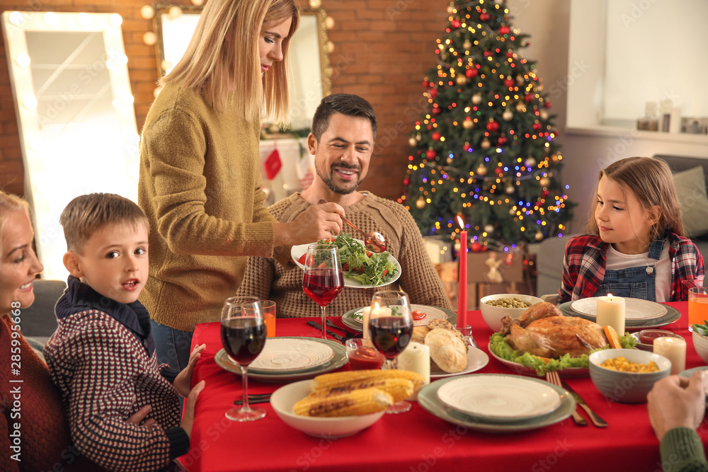 Happy family having Christmas dinner at home
