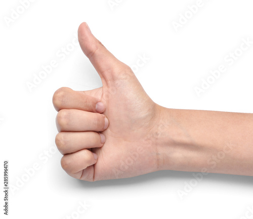 Female hand showing thumb-up gesture on white background © Pixel-Shot