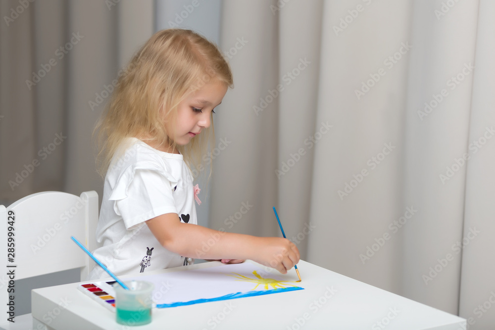 Little girl draws paints.montessori education. Little girl draws paints.montessori education.