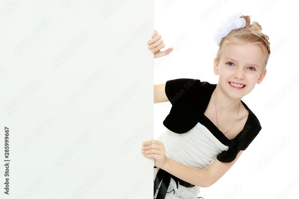 The girl peeks out from behind white banner. The girl peeks out from behind white banner.