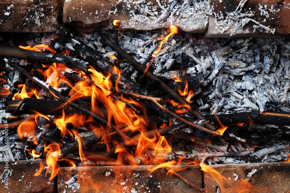 Preparation of a BBQ - wood burning - charcoal glowing Preparation of a BBQ - wood burning - charcoal glowing