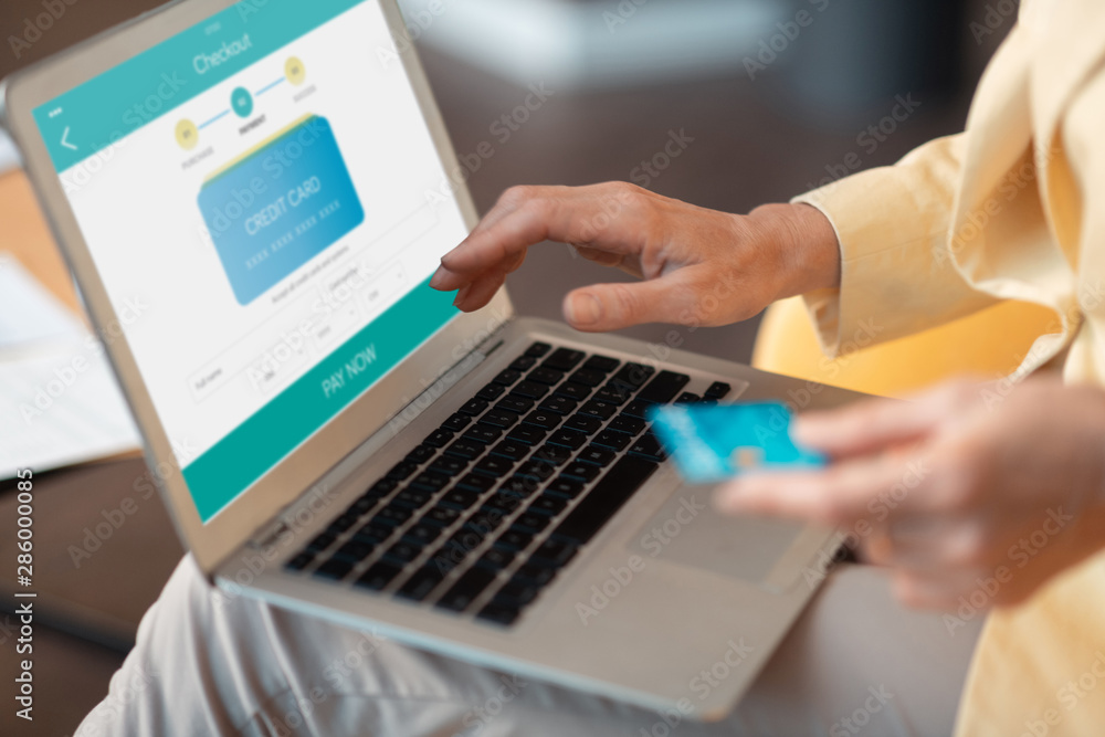 Grey-haired Caucasian business lady making an online payment Grey-haired Caucasian business lady making an online payment