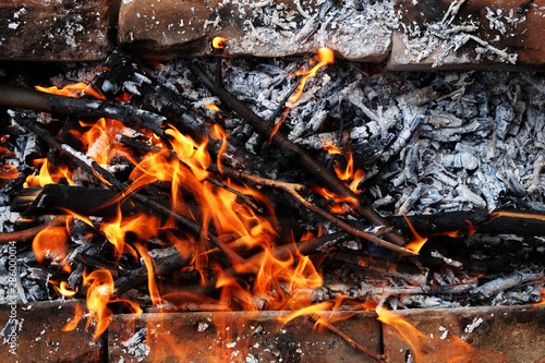 Preparation of a BBQ - wood burning - charcoal glowing © lightscience