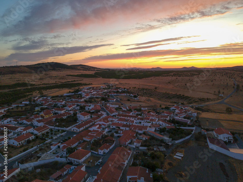 Aerial view from an amazing sunset in Alentejo, Portugal. With agricultural fields in background.