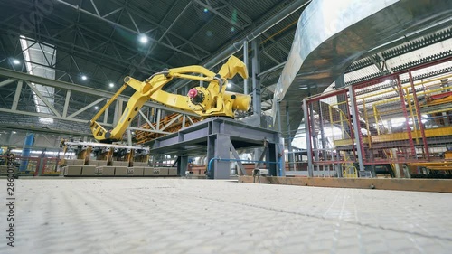 Industrial Robot is transporting bricks at factory. Timelapse. photo