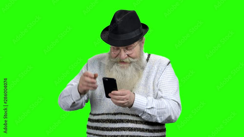 Retired man with beard using mobile phone. Funny old man with smartphone playing game on Alpha Channel background. Senior people, modern technology and fun. Retired man with beard using mobile phone. Funny old man with smartphone playing game on Alpha Channel background. Senior people, modern technology and fun.