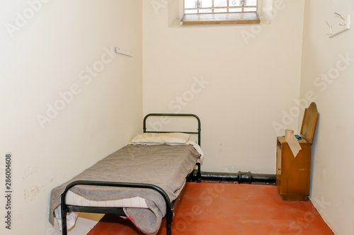 Bed and washstand in a small jail cell
