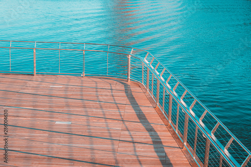 Sunny image of Wooden Bridge and Metal Railing Over Providence River in Rhode Island with Teal and Orange Color Grading