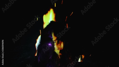 Beautiful woman screaming in burning flame, witch-hunt, dark magic and rituals