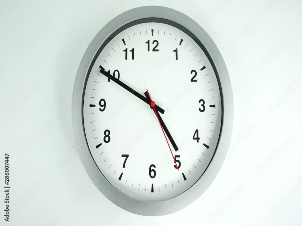 Closeup White wall clock face beginning of time 12.00 am or pm, Clock minute walk slowly, Time concept. Closeup White wall clock face beginning of time 12.00 am or pm, Clock minute walk slowly, Time concept.