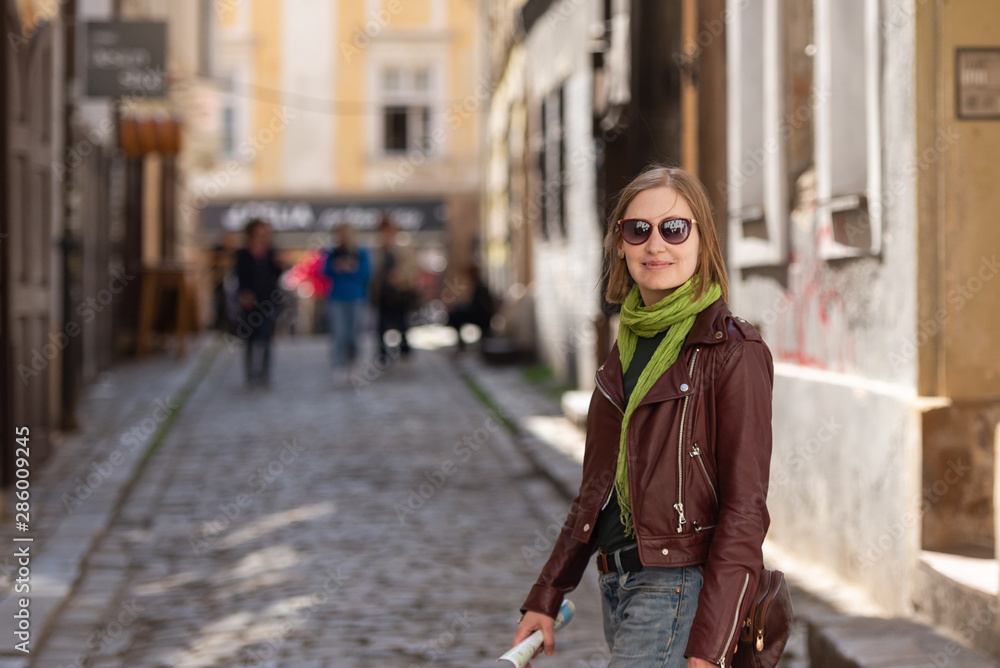 Girl with city map. Walk through Bratislava. Leather jacket and sunglasses. On the old street. Girl with city map. Walk through Bratislava. Leather jacket and sunglasses. On the old street.