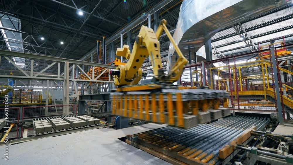 Factory equipment transporting bricks. Automatic robot manipulator in factory. Factory equipment transporting bricks. Automatic robot manipulator in factory.