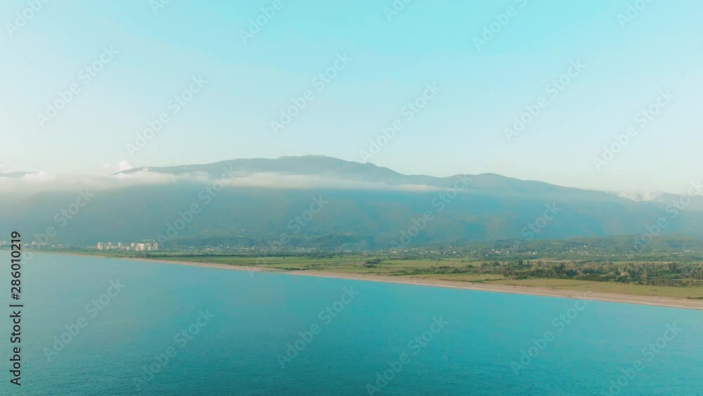 Aerial 4k top view of a beautiful tropical beach and sea waves. Flying over the sandy beach at sunset. Aerial 4k top view of a beautiful tropical beach and sea waves. Flying over the sandy beach at sunset.