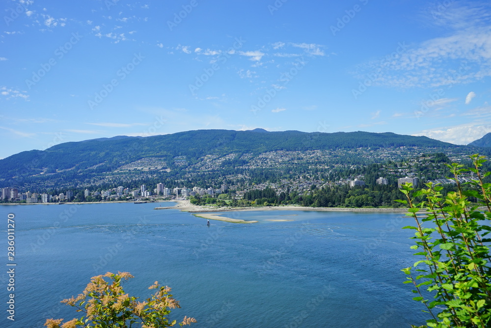 Beautiful Vancouver bay beach and mountain seen from Stanley park