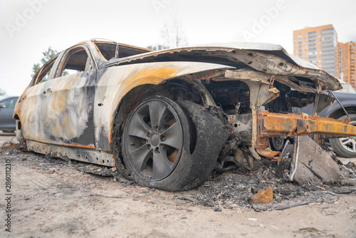 car after deliberate arson. destroyed vehicle after a fire melted is on the street.