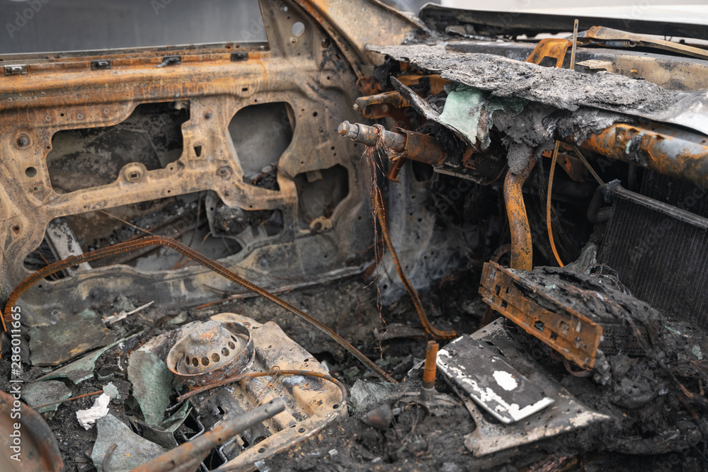 car after deliberate arson. destroyed vehicle after a fire melted is on the street. car after deliberate arson. destroyed vehicle after a fire melted is on the street.