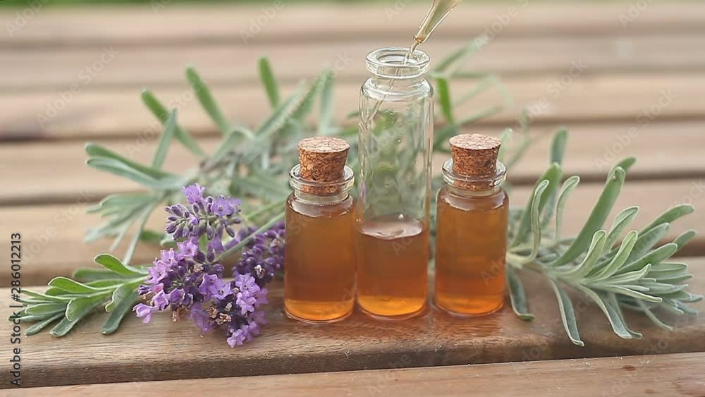 lavender essential oil in beautiful bottle on table lavender essential oil in beautiful bottle on table