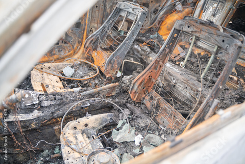 car after deliberate arson. destroyed vehicle after a fire melted is on the street.