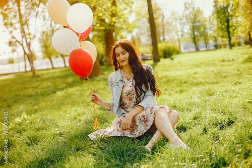 young and bright girls wallking in the summer park with balloons photo