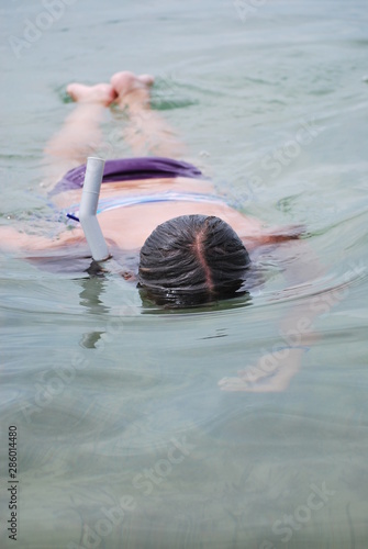 girl snorkeling in sea