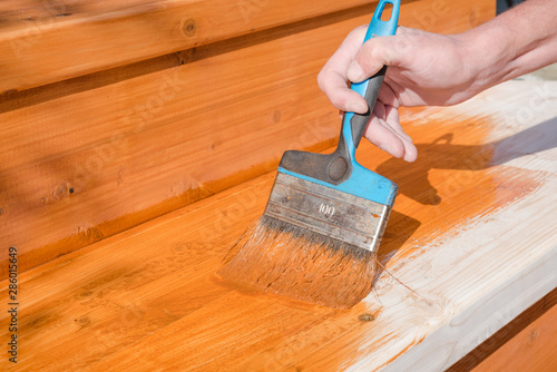 Paint the porch with orange paint. Decorate the terrace. Paint the boards with a wide brush. To make repairs.