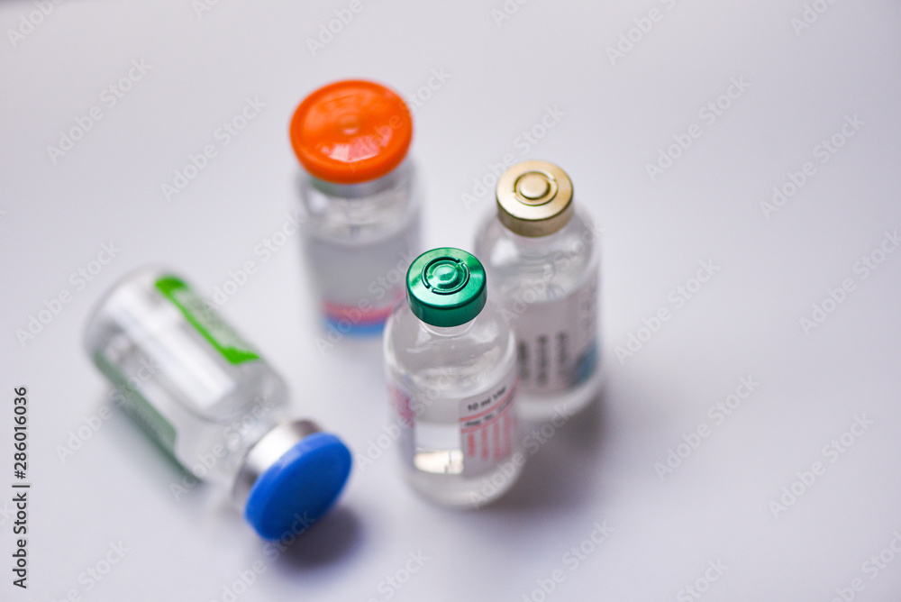 Medicine bottles glass for syringe injection needle on gray background - Medication drug bottle equipment medical tool for nurse or doctor Medicine bottles glass for syringe injection needle on gray background - Medication drug bottle equipment medical tool for nurse or doctor
