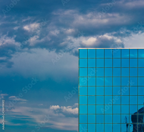 Skyscraper Tiled Windows And Dramatic Cloudy Sky