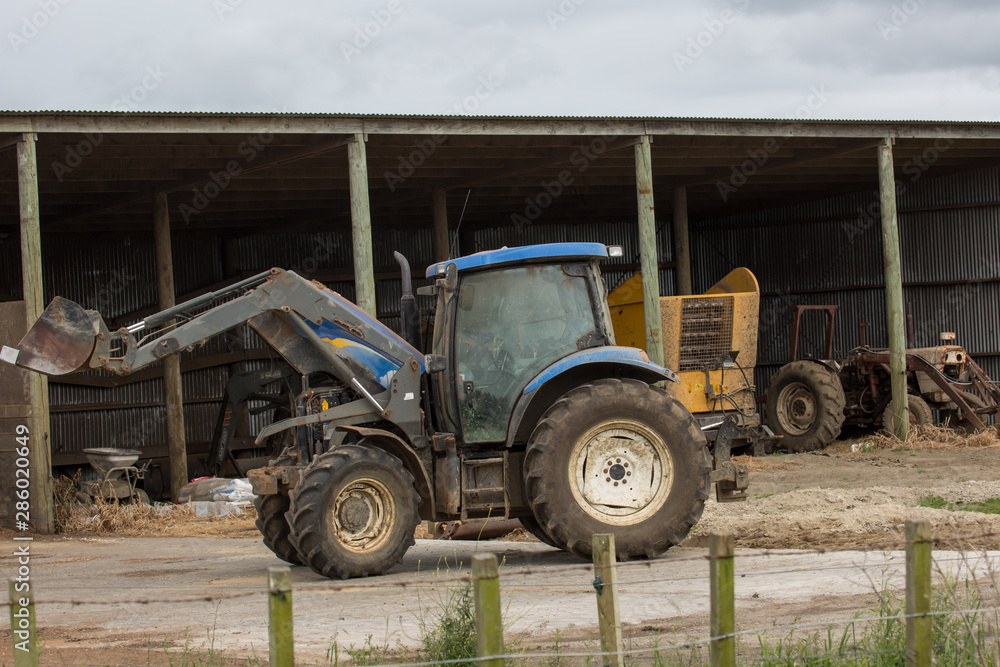 Obraz premium Farm tractor on the farm in rural countryside