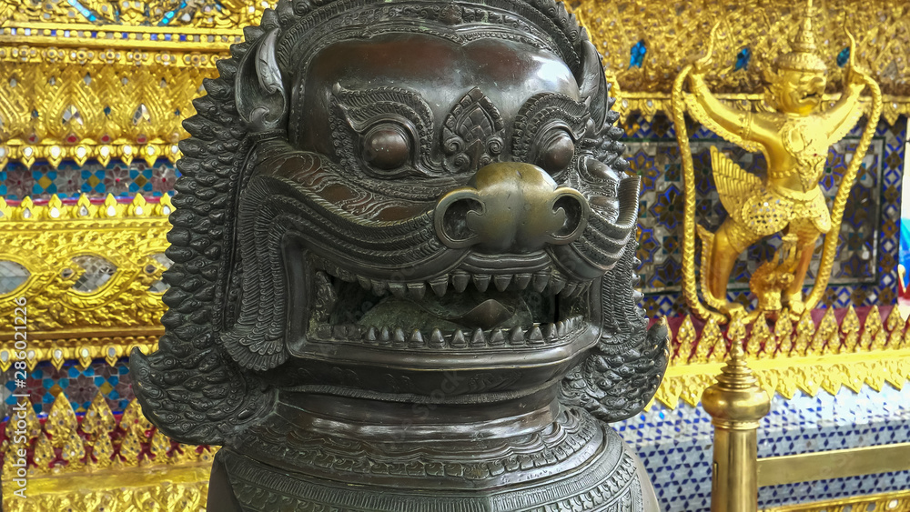 close up of a bronze chinese lion statue at wat phra kaew temple in bangkok