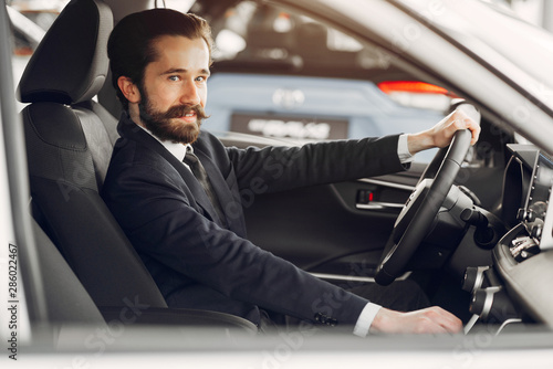 Man buying the car. Businessman in a car salon © prostooleh