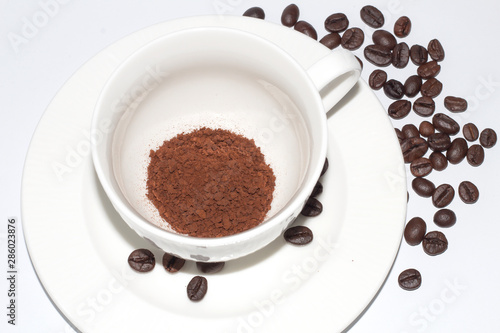 cup of coffee with beans isolated on white background