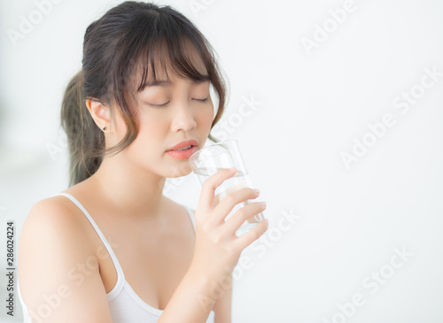 Beautiful portrait young asian woman caucasian smiling with nutrition thirsty and drinking glass of water mineral with fresh and happy  asia girl diet for healthy care and wellness  lifestyle concept.