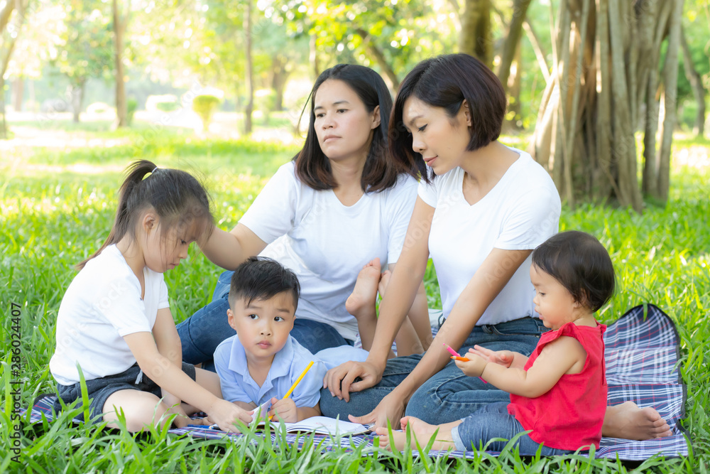 Beautiful young asian parent family portrait picnic in the park, kid or children and mother love happy and cheerful together in summer at garden, lifestyle concept. Beautiful young asian parent family portrait picnic in the park, kid or children and mother love happy and cheerful together in summer at garden, lifestyle concept.