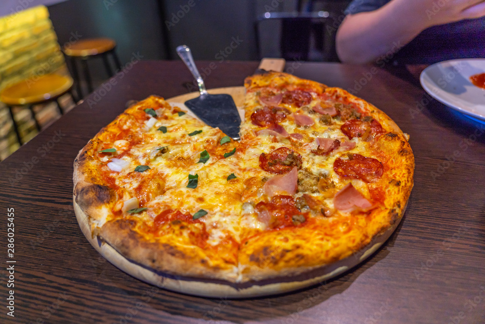 Fresh handmade Italian pepperoni pizza topped with cheese and sausage Fresh handmade Italian pepperoni pizza topped with cheese and sausage