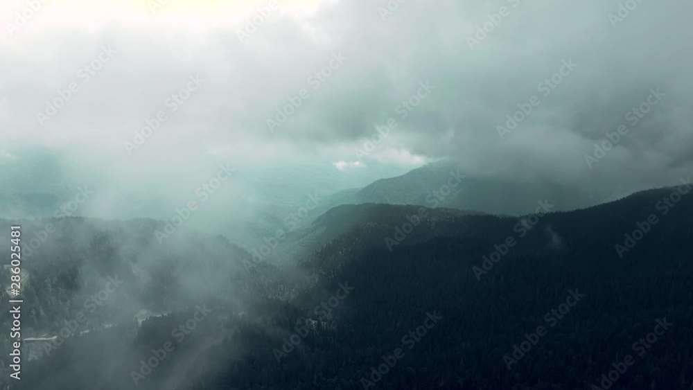 Aerial 4k view. Flying through the clouds above mountain tops. High peaks wonderful morning sunrise natural Landscape. Aerial 4k view. Flying through the clouds above mountain tops. High peaks wonderful morning sunrise natural Landscape.