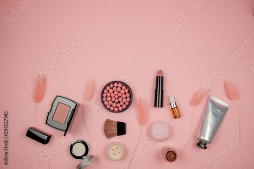 Makeup cosmetic flay lay pink cloral background