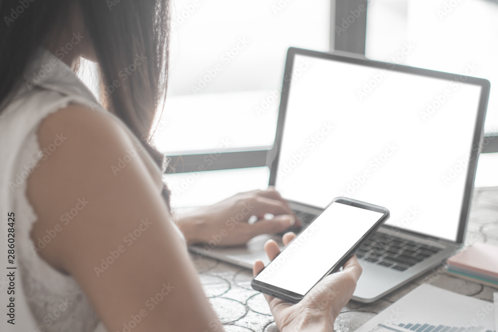 Mockup image of close up business woman working with smartphone laptop and documents in office, mockup concept Mockup image of close up business woman working with smartphone laptop and documents in office, mockup concept