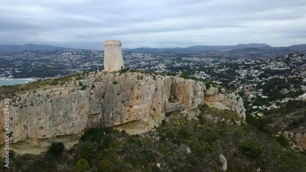 drone flying towards a tower on a mountain in Spain drone flying towards a tower on a mountain in Spain