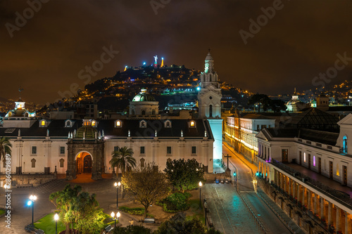 The cathedral of Quito at night and a view over the Main Square (Plaza Grande) of the city and the Panecillo with the Virgin of Quito, Ecuador, South America. photo