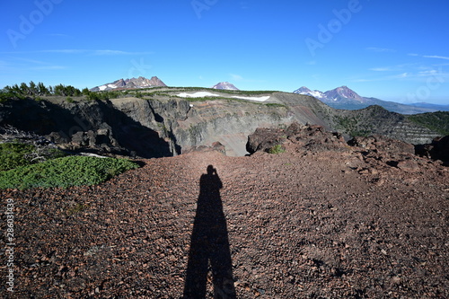 Photographer's shadow in early morning light at end of Tam McArthur Rim Trail in Three Sisters Wilderness, Oregon. photo