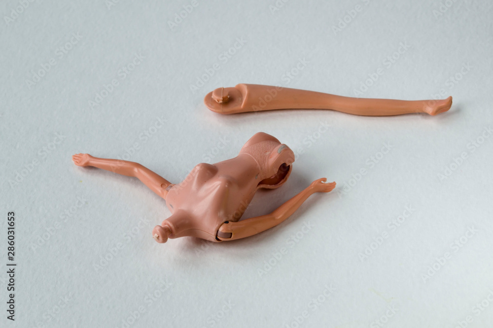 The concept of the state of grief and destruction, illness. Broken doll on a white background. The concept of the state of grief and destruction, illness. Broken doll on a white background.