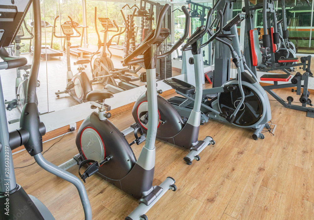 rows of stationary bikes equipment health exercise for bodybuilding in gym modern fitness center room rows of stationary bikes equipment health exercise for bodybuilding in gym modern fitness center room