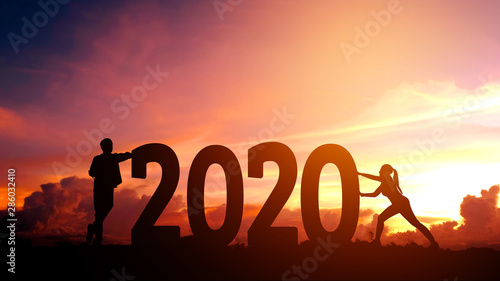 2020 Newyear  Couple tries to push number of 2020 Happy new year concept