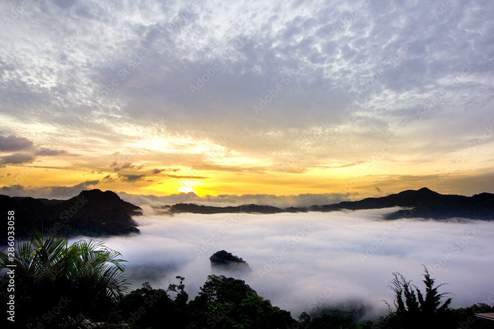 Misty sunrise over mountain with dramatic cloud and sky at Phu Langka in Phayao province, Thailand Misty sunrise over mountain with dramatic cloud and sky at Phu Langka in Phayao province, Thailand