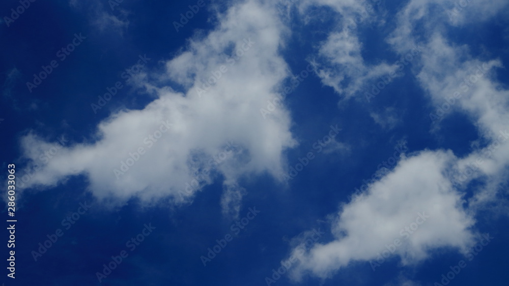 Two white clouds on the blue sky background Two white clouds on the blue sky background