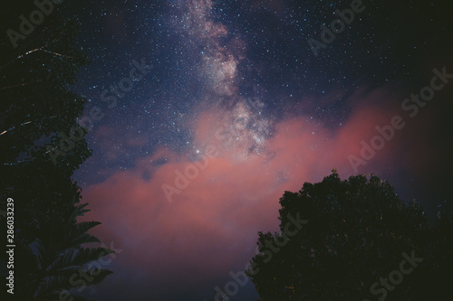 Night sky and the Milky Way with pink clouds