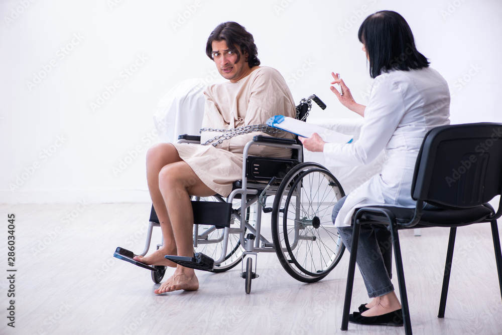 Old female psychiatrist visiting young male patient Old female psychiatrist visiting young male patient